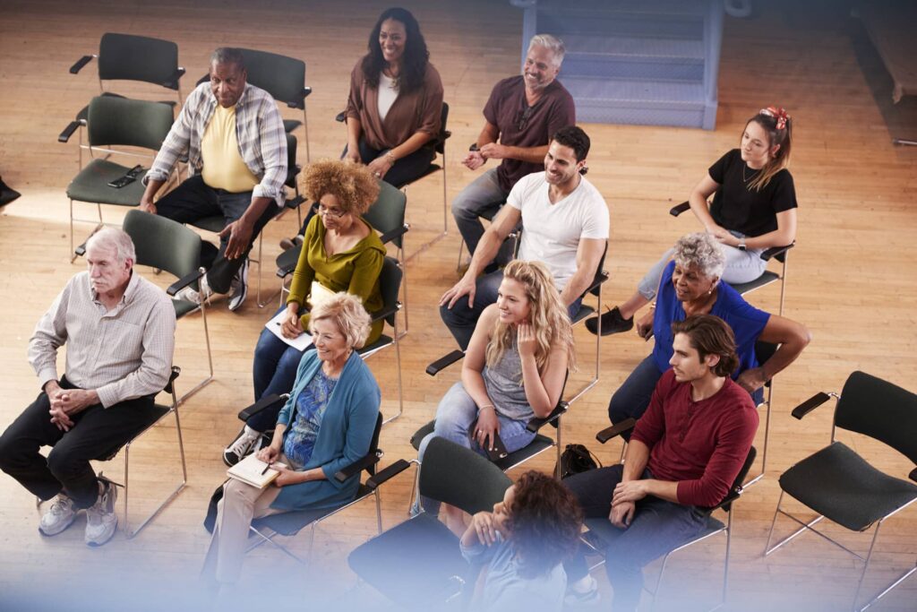 Community members sit in a meeting.